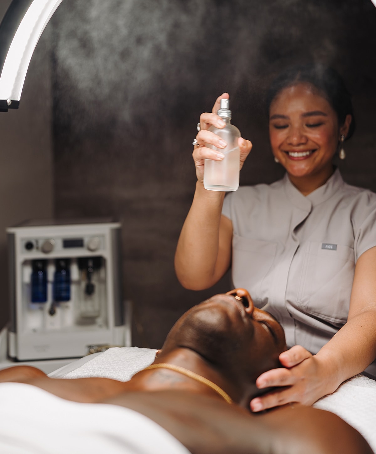 Skincare treatment with facial mist application.