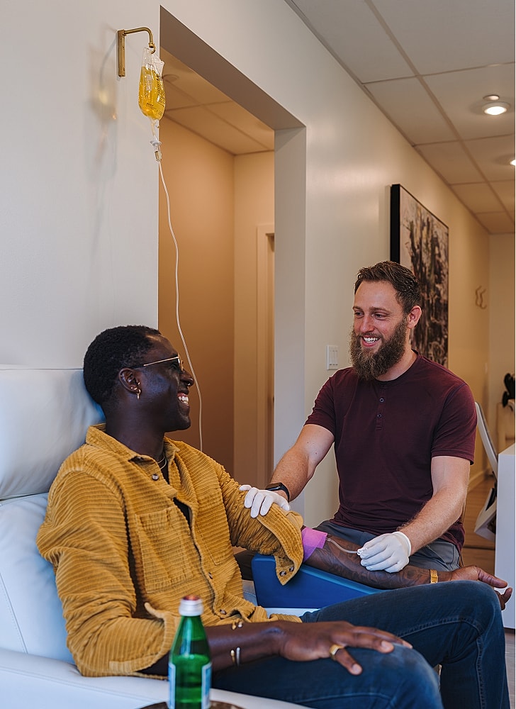 Patient enjoying IV treatment with a nurse.