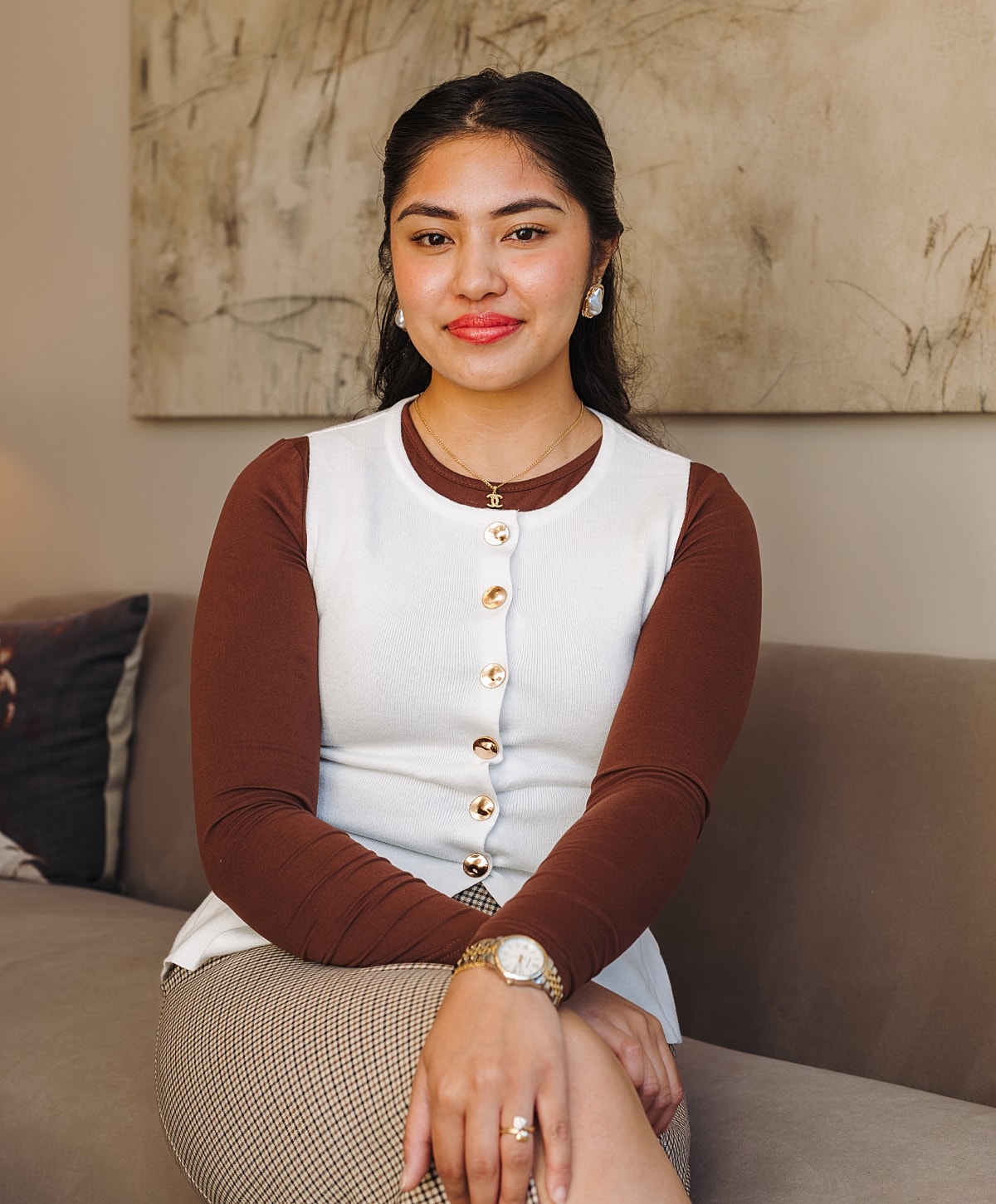 Young woman posing elegantly on a couch.