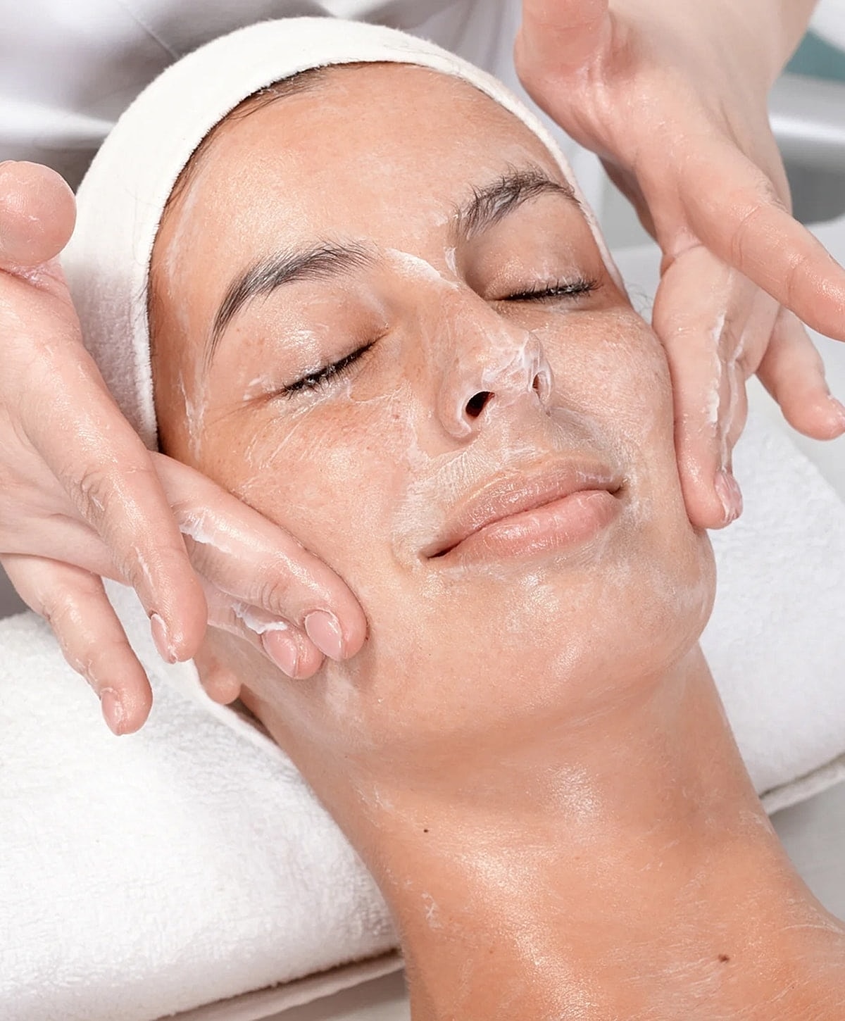 Facial treatment with cleansing mask application.