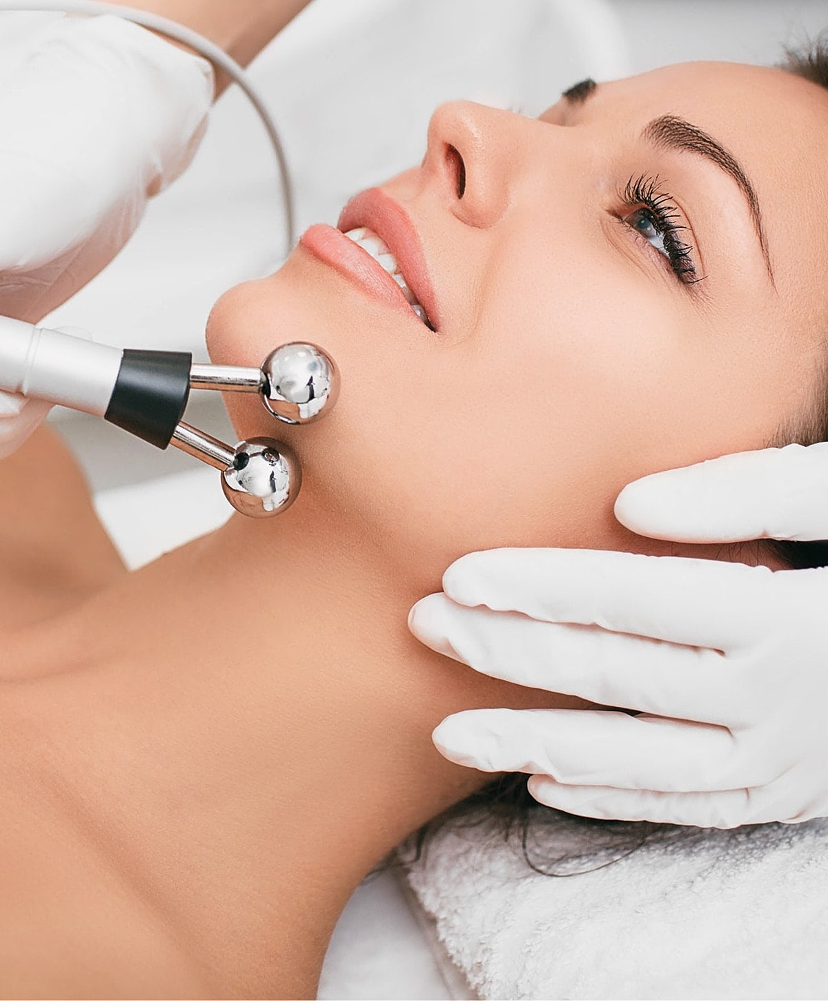 Facial treatment with beauty device in spa.