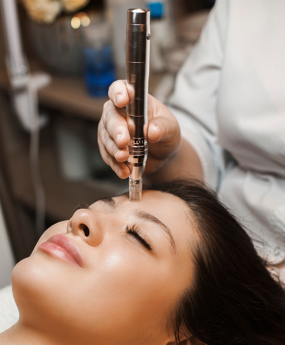 Microneedling treatment on a woman's face.