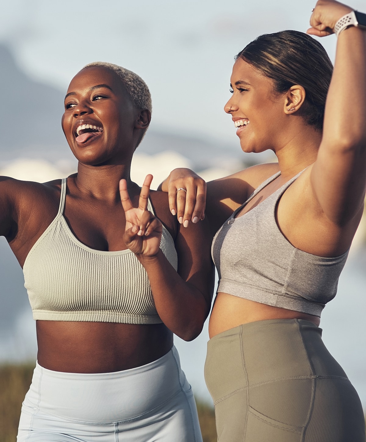 Two friends celebrating fitness outdoors.