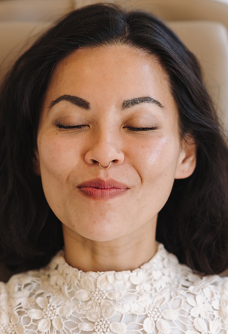 Woman with closed eyes and serene expression.