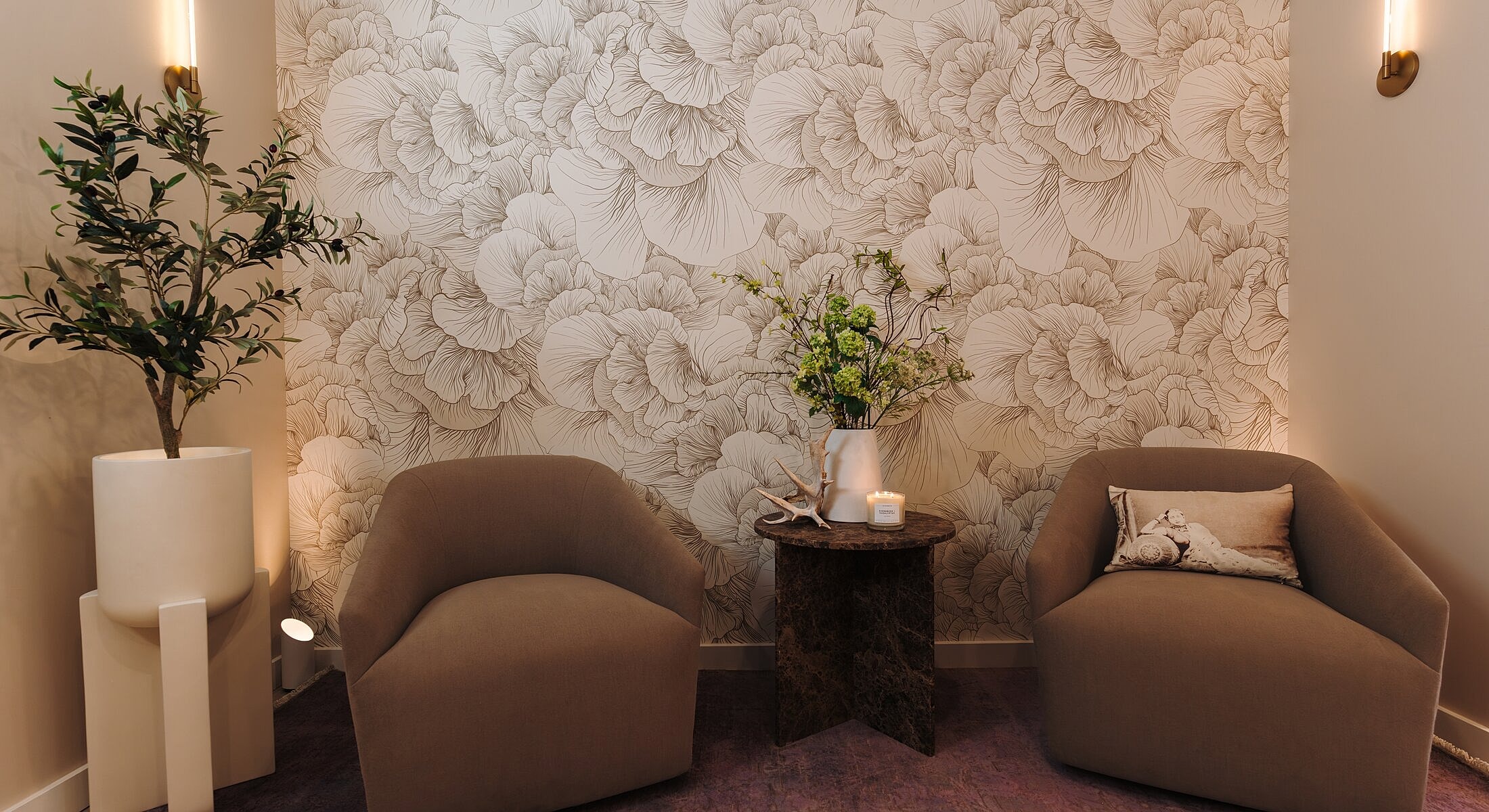 Stylish seating area with floral wallpaper design.