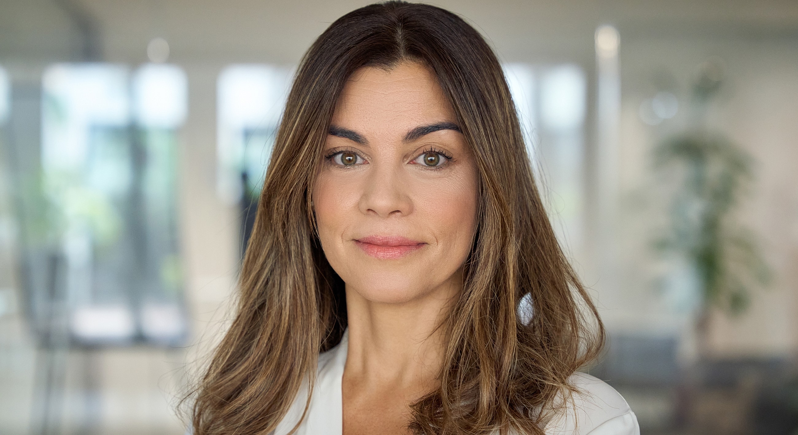 Professional portrait of a woman with long hair.