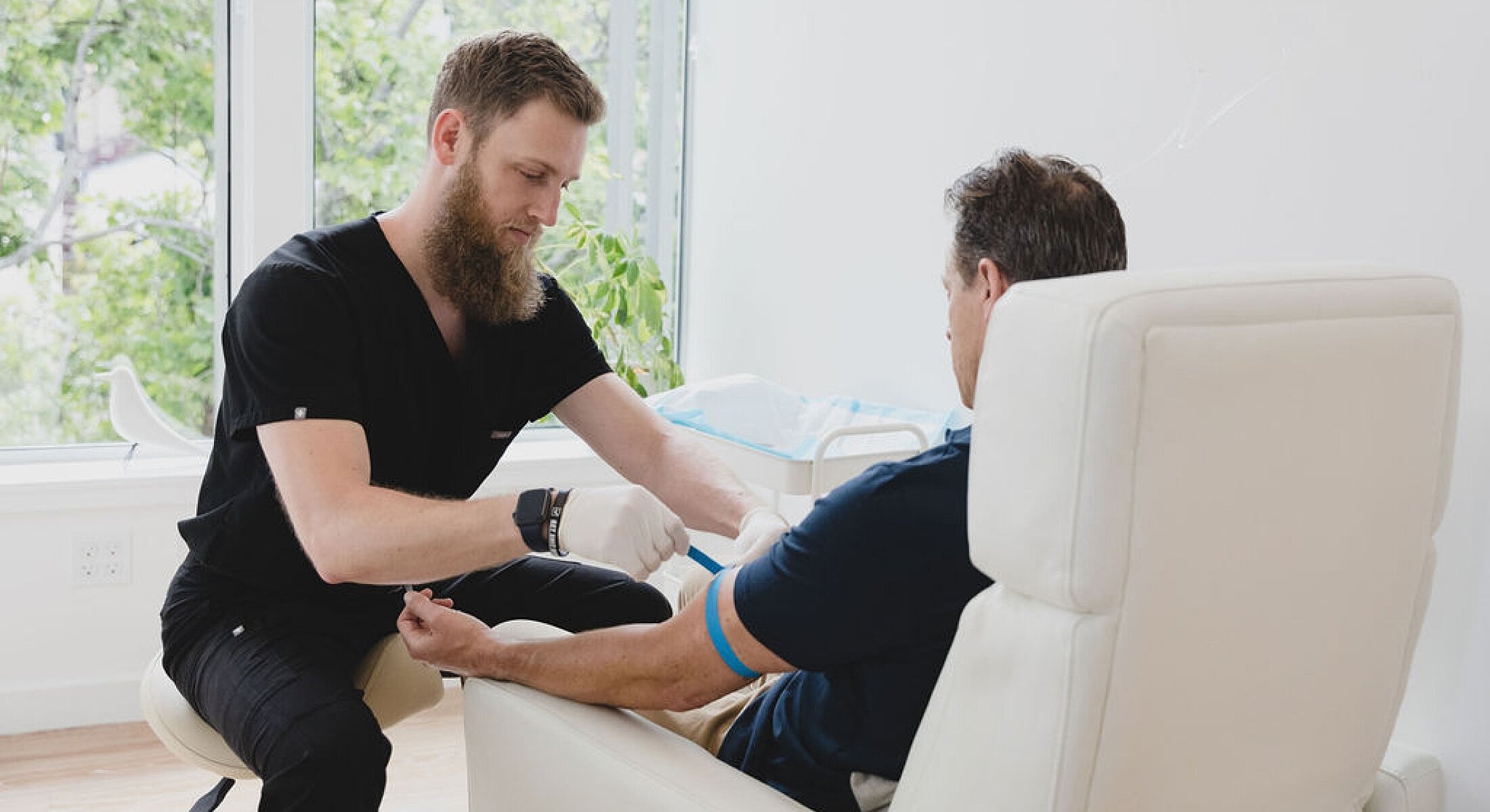 Medical professional drawing blood from a patient.